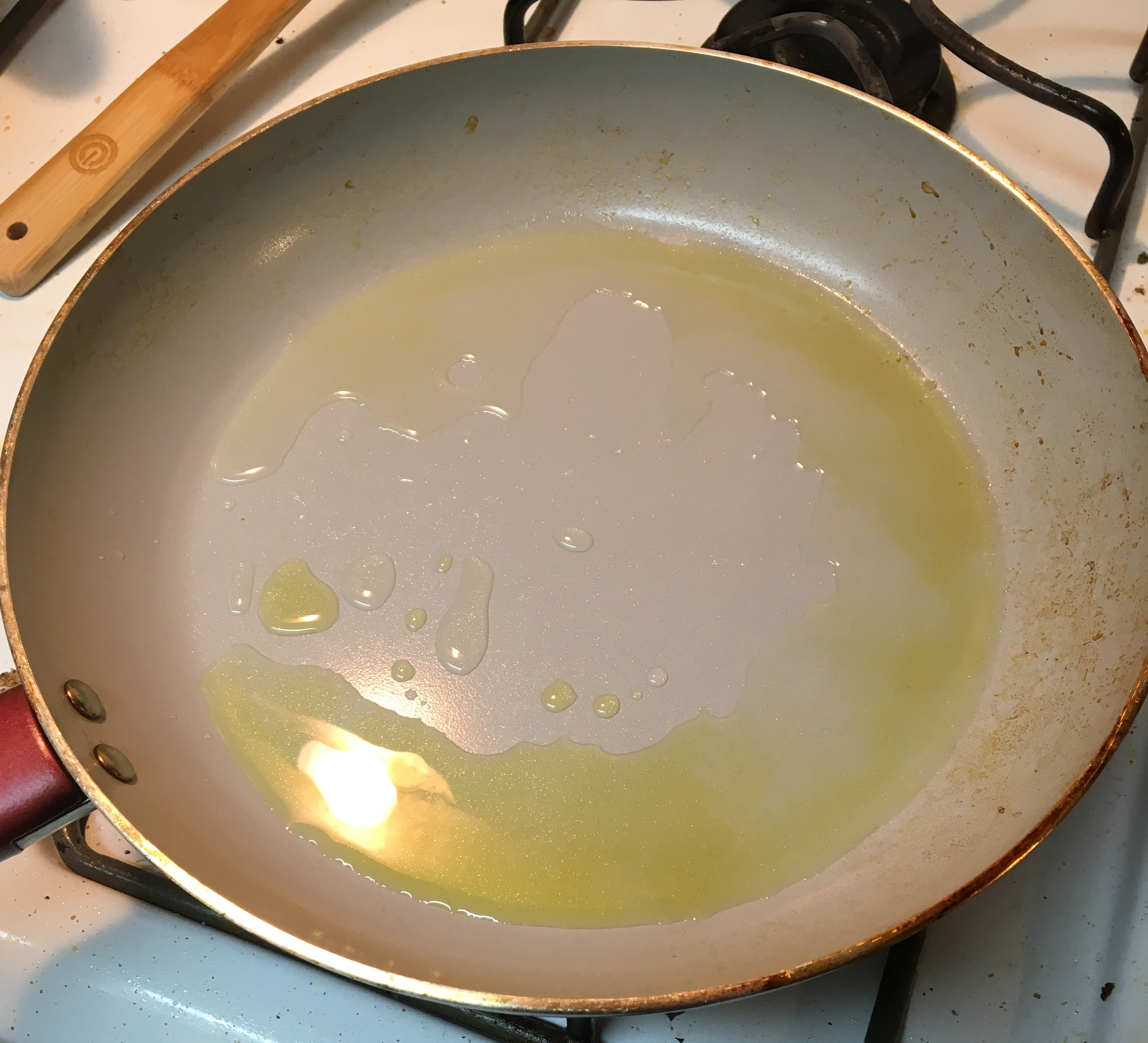 A hot pan with olive and standard oil on the bottom. 