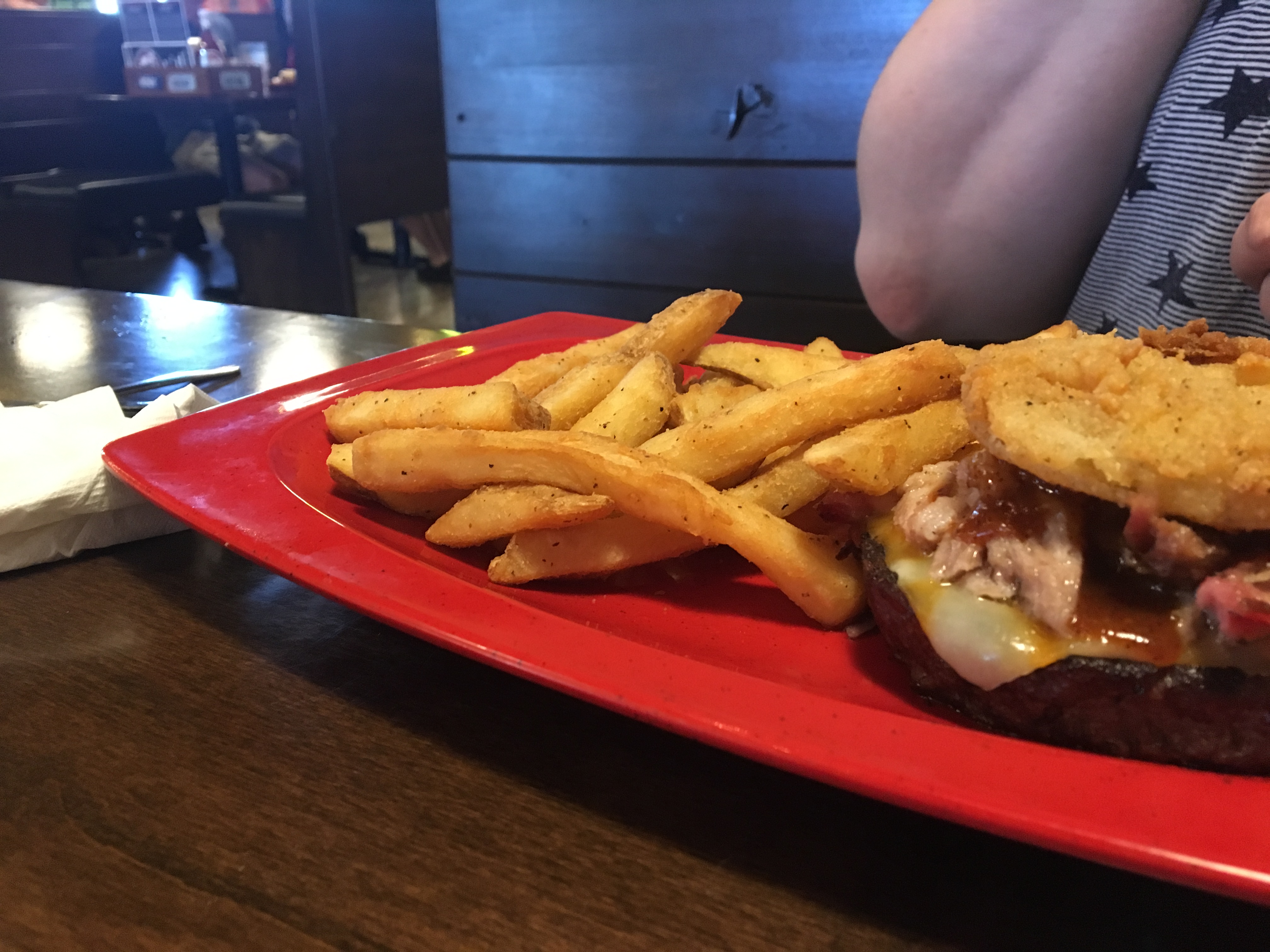 bunless burger topped with pulled pork and a fried green tomato